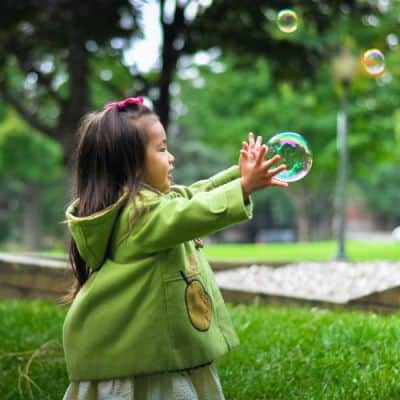 Little Girl Plays With Bubbles