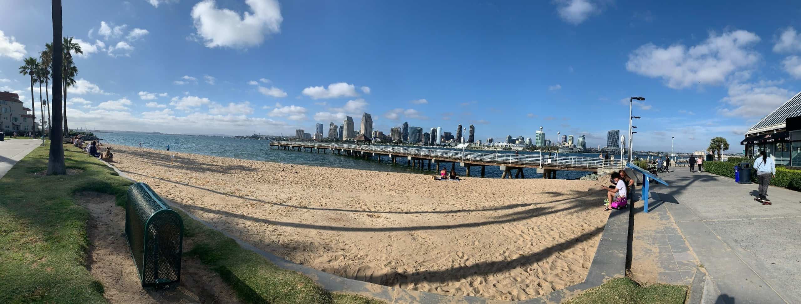 San Diego skyline across the bay with beach and waterfront pier